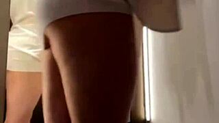 A hot chick is trying on clothes in the fitting room, getting fucked publicly